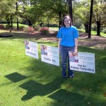 Standing with the sign Uncle Charlie sponsored