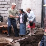 Travis helping a church member 